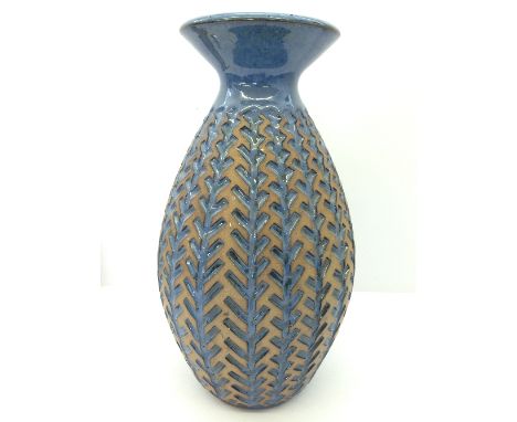 A modern Poole Pottery Atlantis Revival carved vase by Alan White with blue glaze.