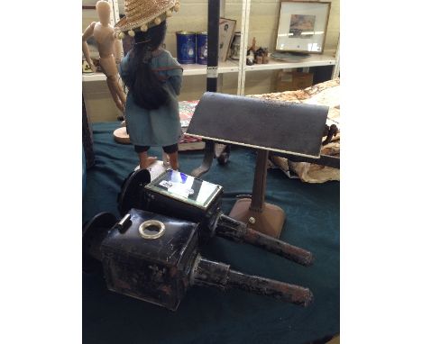 A student's electric desk lamp together with a pair of coach lamps.
(R9)