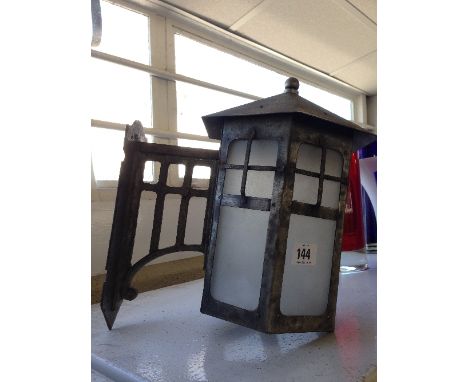A metal porch lantern on original bracket.