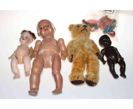 Vintage teddy bear and collection of dolls including bisque head doll.