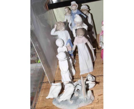 Eleven figurines including Lladro, Nao and Spode.