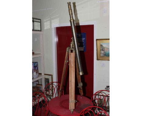 Brass vintage style telescope on wood tripod base.