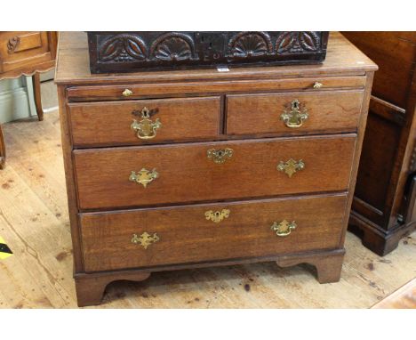 Georgian oak chest having pull out writing surface above two short and two long drawers on bracket feet, 82cm by 93cm.
