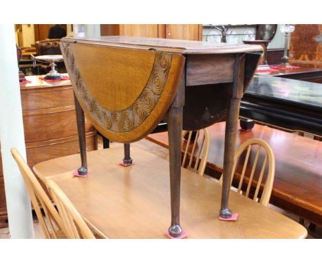 Carved oak gate leg dining table on pad feet, 74cm by 110cm (closed).