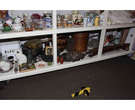 Full shelf of collectables including walking sticks, Imari plates, Staffordshire Red Riding Hood group, enamel bread bin, bra