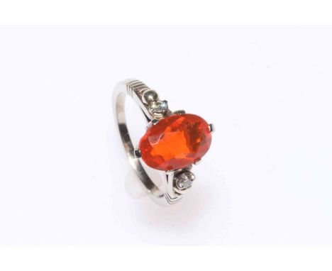 Fire opal and diamond ring set in 14 carat white gold.