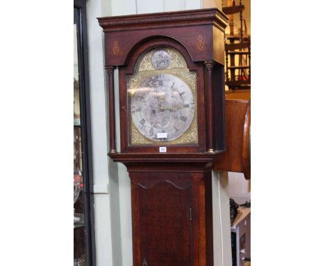 Antique oak eight day longcase clock having arched brass and silvered dial.