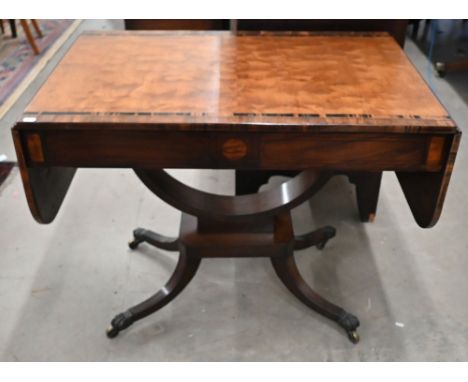 A Regency mahogany and crossbanded coromandel sofa table, the drop leaf top over two frieze drawers on curved frame and quadr