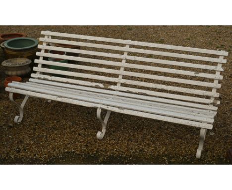 A classic wood-slat garden bench on three wrought steel mounts, painted white, 183 cm long 