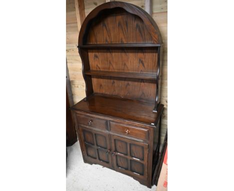 An Ercol style cottage dresser, the domed open rack over two drawers and cupboards, 93 cm w x 40 cm x 183 cm h 