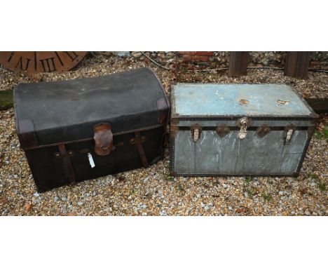 A vintage dome top motoring style trunk in 'tarred' protective sleeve with leather straps 