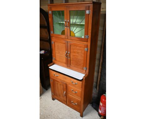 A vintage 1930s American 'Hoosier' kitchen cabinet, with part lead and coloured glass panelled doors over an arrangement of c