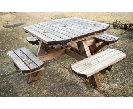 A weathered one piece wooden garden four bench seat picnic table, the table 107 cm x 107 cm x 74 cm h 