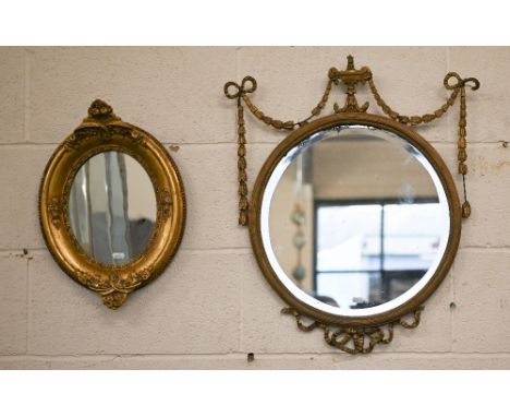 A bevelled circular wall mirror in decorative neoclassical style gilt frame, 45 cm diam to/w smaller gilt framed oval mirror,