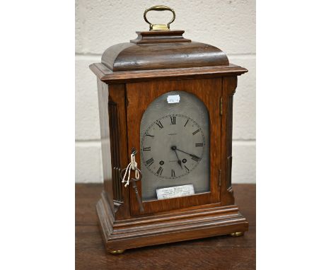 An antique French oak mantel clock with silvered dial inscribed for Ramsay of Dundee, striking on a coiled gong, 45 cm high o