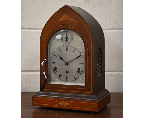 An antique German inlaid mahogany lancet-cased mantel clock with silvered dial, striking and chiming on five coiled gongs, 43