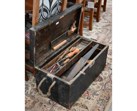 A stained wood box containing a quantity of vintage tools 