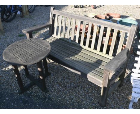 A weathered teak garden bench, 161 cm long to/with a small circular table, a/f (2) 