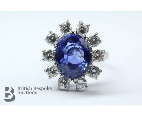 A stunning natural cornflower blue 5ct sapphire and diamond ring. The intense oval-cut Ceylonese sapphire of 5.13 cts measure