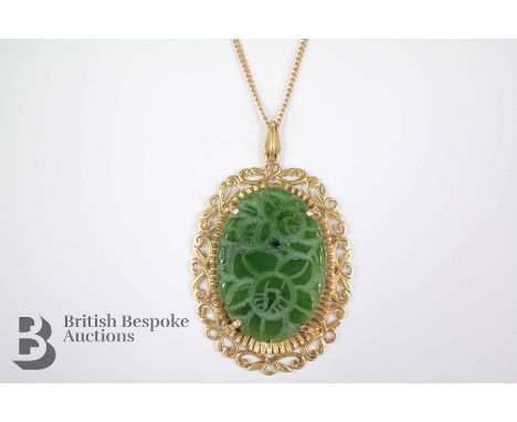 An Oval Jade Pendant, the stone approx 55 x 35 mm, the overall size of the pendant approx 50 x 35mm, suspended from a 9ct gol