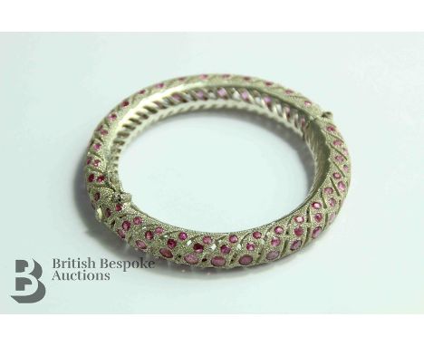 Indian silver filigree ruby bangle, set with approx 155 circular rubies, inner diameter 50 mm.&nbsp;