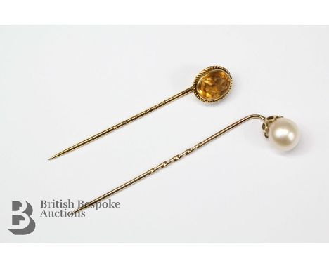 A 9ct pearl stick pin, the pearl measures approx 9mm d, together with a 9ct citrine glass stick pin in a rope setting. (2)