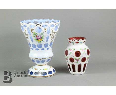 Blue Bohemian enamel overlay glass vase, painted with flowers, approx 22 cms h, together with a cranberry enamel overlay glas