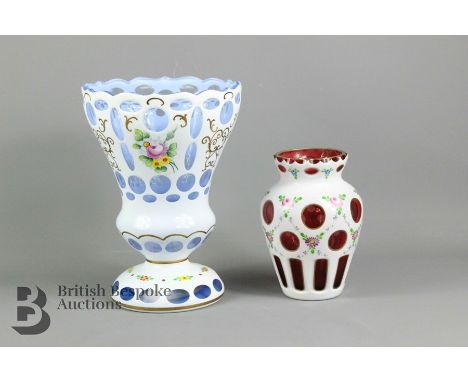 Blue Bohemian enamel overlay glass vase, painted with flowers, approx 22 cms h, together with a cranberry enamel overlay glas