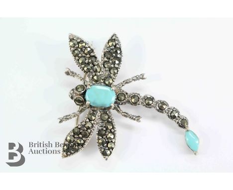 A silver dragonfly brooch, with turquoise cabochon eyes, approx 38 x 35mm, approx 6.9 gms.