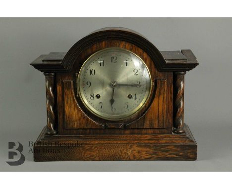 A early 20th century oak mantel clock, steel face with numeric dial, approx 34 x 28 x 15 cms. (split in the right hand case)
