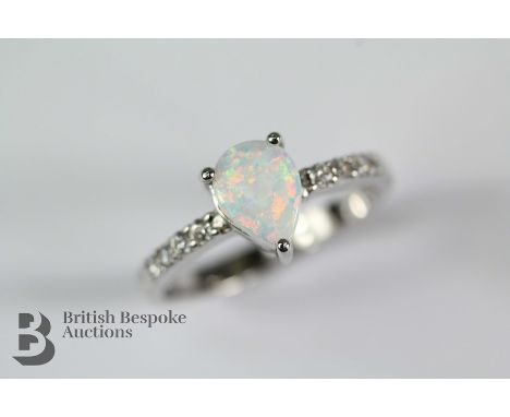 Silver and Cubic Zirconia ring, size N, set with a central opal pear-shaped stone approx 7 x 6mm, approx 2.3 gms,.&nbsp;