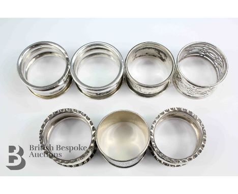 Seven silver napkin rings, this lot comprises six Birmingham hallmark napkin rings various date marks and Siamese silver napk