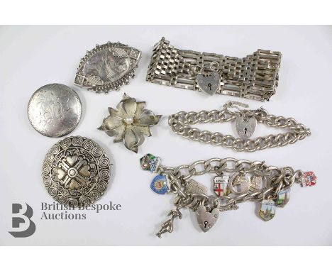 Three silver brooches, including a floral engraved disc brooch, Victorian engraved elliptical brooch, a floral brooch and a P