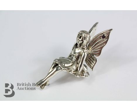 Silver winged nymph, the wings set with ruby cabochon, approx 40 x 17mm, approx 11.3 gms.&nbsp;