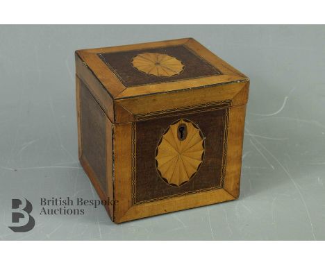 Satin and fruitwood tea caddy, with shell motif to top and decorative inlay, Sheraton-style, approx 13 x 13 x 13 cms.&nbsp;