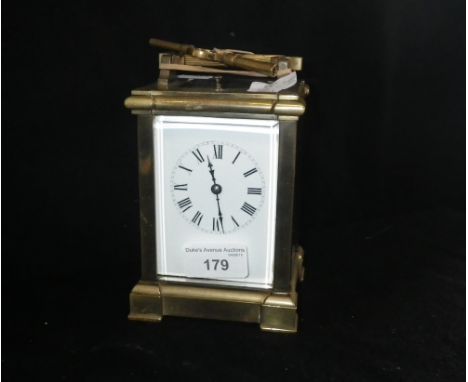 A brass-cased carriage clock