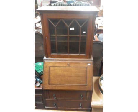 A 1920's mahogany bureau of small proportions with raised glazed bookcase above, 21.5" wide