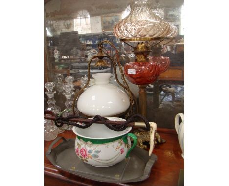 A Victorian style oil lamp with cranberry glass reservoir, a similar hanging lamp, a riding whip, pewter tray and sundry item