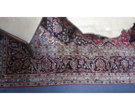 A red ground Persian design carpet with all over floral decoration, c.153" x 97"