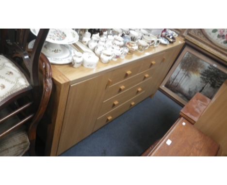 A contemporary light oak coffee table, another similar, an oak faced melamine sideboard, two melamine bookcases, a melamine d