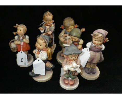A collection of six Hummel figures of children in various poses