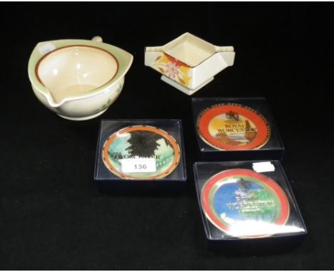 A Clarice Cliff stylised jug with hand painted decoration, a similar jug and three Royal Worcester saucers with Art Deco desi