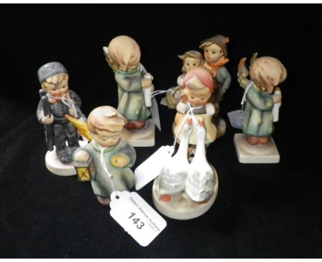 A collection of Hummel figures of children in various poses