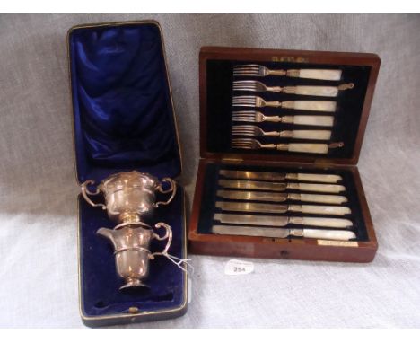 A silver plated mother-of-pearl handled cased fish knife and fork set and a cased silver jug and two handled bowl suite (2)