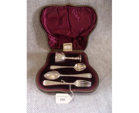 A cased silver christening set, comprising a small fitted goblet, two spoons and a fork with all over engraved decoration in 