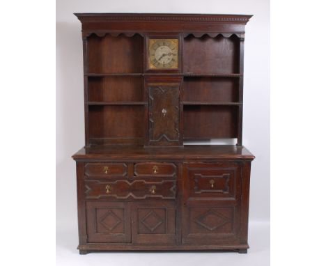 An antique oak house-keepers dresser, the upper section inset with an 11" longcase brass clock dial and movement signed Phili