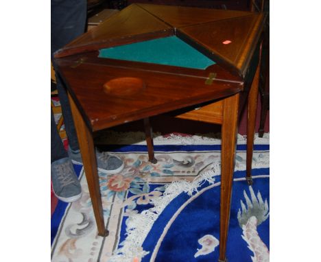 An Edwardian mahogany, satinwood crossbanded and further strung envelope card table, having typical rotating and folding acti