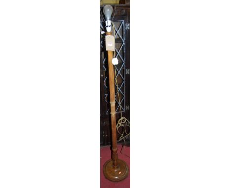 A mahogany turned and reeded standard lamp