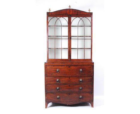 A Regency mahogany and inlaid secretaire bookcase, the upper section having twin astragal glazed doors enclosing adjustable s