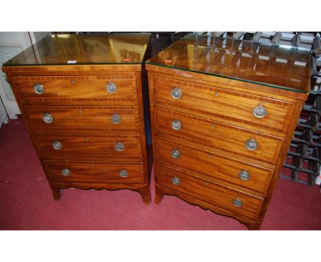 A pair of 19th century mahogany and satinwood strung chests of four long drawers on outswept bracket supports, width 55cm
